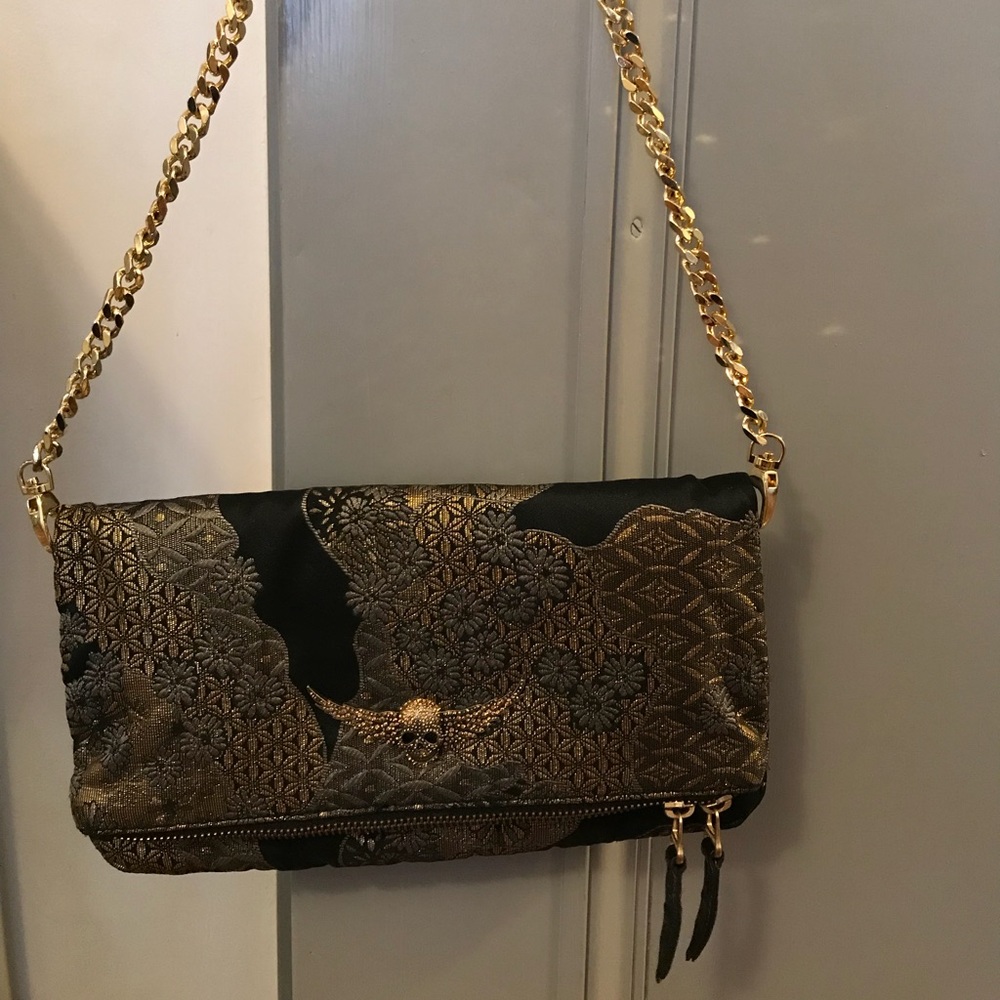 Black, gold and grey woven flap bag.